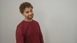 © Krakenimages.com - Young hispanic man smiling confidently in casual attire against an isolated white background, exuding charm and warmth with a friendly demeanor and stylish appearance.