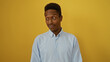 © Krakenimages.com - Young african man standing over isolated yellow background in a casual pose, showcasing confidence and charisma.