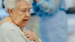 © Halfpoint - Banner of old woman terminal diagnosis or serious health issues. Elderly patient holding her chest, feeling pain.