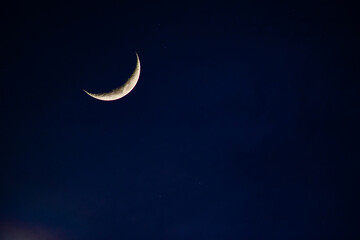 Wall Mural - amazing crescent moon on dark blue night sky background.universe filled with stars, nebula and galax