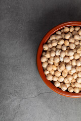 Wall Mural - Earthenware bowl full of chickpeas on a kitchen worktop in a zenithal photograph