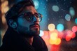 © Michael - Stylish young man wearing glasses and winter clothes looking up in wonder at the city lights and falling snow at night