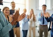 © Running opossum - Diverse business team clapping hands, celebrating success in modern office