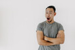 © Sevendeman - Wow and happy face of Asian man in grey t-shirt isolate on white.