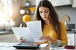 © Adobe Contributor - Woman reviewing documents in kitchen