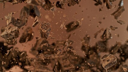 Poster - Freeze motion of flying group of raw chocolate pieces.