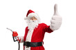 © Ljupco Smokovski - Santa Claus holding a fuel injection gun and gesturing thumbs up