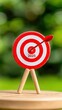 © pvl0707 - A small calendar displaying the year 2025 is positioned next to a red and white target icon on a wooden plate, set against a blurred green background