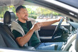 © New Africa - Man with cup of coffee driving modern car