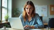 © Trust Fish - Frustrated woman shouting at laptop in modern office, showcasing intense emotions and challenges