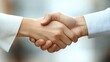 © Pat J. - Close-up of a firm handshake between two business partners, emphasizing collaboration and trust