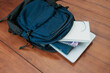 © Nurma - Blue backpack with books, notepad and laptop for student or working on the wooden table, concept back to school or working.