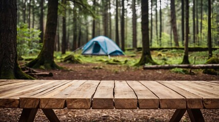 Wall Mural - A empty wooden table in the foreground with a tent and trees in the blurred background, suggesting an outdoor camping scene in a forest