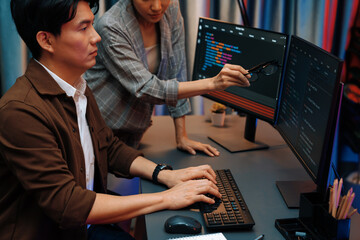 Wall Mural - it developers discussing with point to intelligent website development coder system running data onl