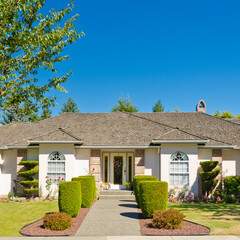 Wall Mural - Entrance of grey painted luxury house in summer with stair steps and nice landscape in Vancouver, Canada, North America. Day time on June 2024.