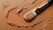 © Evgenii - A close-up of brush spreading creamy foundation in a rich mocha mousse color tone on a smooth textured surface, concept of color of year 2025, modern trend