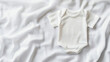 © PHOTOGRAPHY - White shirt with no design on it. The shirt is hanging on a gray background. The shirt is a simple design with no pattern or color