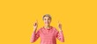 © Pixel-Shot - Portrait of mature woman pointing at something on yellow background