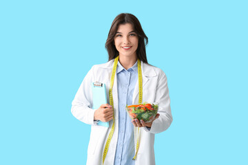 Sticker - Female nutritionist with clipboard and healthy food on blue background