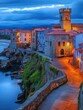 © Johannes - Castro Urdiales old town at dusk with Santa Ana Church and Castillo Lighthouse in Cantabria Autonomous Community of Spain, Europe