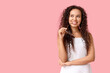 © Pixel-Shot - Beautiful thoughtful African-American woman with sunglasses on pink background