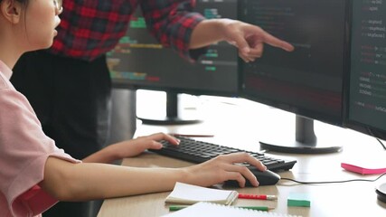 Slow motion back end or software developer manager supervising his team on new application program development on debugging and solving complex code algorithms on monitor. Burgeoning