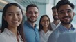 © vefimov - Friendly business group smiling for a picture in an office environment.