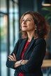 © vefimov - Smiling professional woman in office environment.