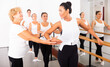 © JackF - Elderly ballet teacher helps female students in a ballet school