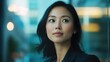 © Pelayo - A confident young Asian woman in business attire is captured in a close-up shot. She exudes professionalism and focus, showcasing a modern business look with a strong, determined expression