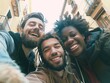 © vefimov - Three young adults laughing and smiling at the camera, taking a selfie in an urban setting.