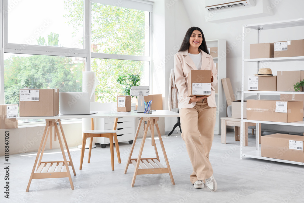 Pregnant seller with parcel box in online store warehouse