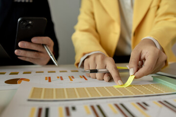 Businessman brainstorming to find strategies to increase revenue for the company. Two coworkers are discussing about the work in progress. Two employees are working as a team. Business meeting.