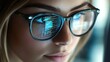 © Maria Mikhaylichenko - A close-up image of a person with glasses reflecting computer code, symbolizing the deep focus and concentration associated with programming and technology.