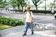 © Queenmoonlite Studio - Full Length of Happy Young Man Student With Backpack Walking at The Park