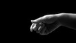 © ABIDZAR ALFAREZ - Close-up grayscale image of a hand reaching out in a dark background.