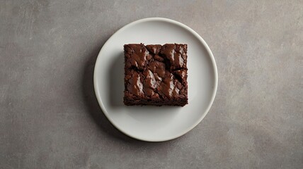 Chocolate brownie on paper on light grey base top view flat lay looking down