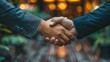 © MUHAMMADALAN - Two businessmen shaking hands, signifying a successful deal or partnership.
