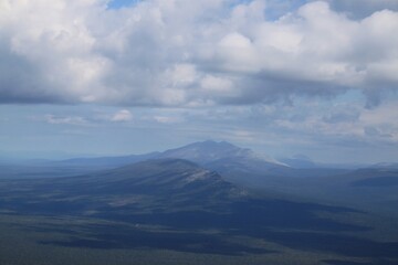 Wall Mural - A mountain range is visible in the distance with a blue sky above