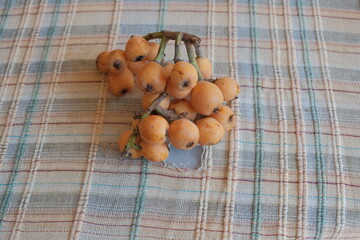 loquat or Eriobotrya japonica. Half and whole ripe loquat fruits on white background