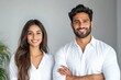 © PRASANNAPIX - young indian couple sitting together on white background
