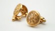 © Sakina - A pair of gold cufflinks with engraved details, isolated on a clean white background, capturing their elegant and refined design.
