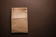 © saleem - Brown paper bag on a dark surface with a minimalist design