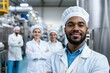 © Elena - Confident food industry team smiling in factory.