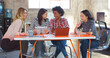© Monkey Business - Group Of Female Designers Around Table Having Meeting In Creative Modern Office