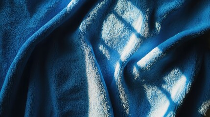 Wall Mural - sunlit blue towel backdrop with soft textures creating calming shadows and highlights ideal for phot
