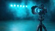 © svastix - A professional camera mounted on a tripod, featuring a blue illuminated lens against a blurred background of lights, ideal for tech and photography themes.