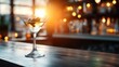 © svastix - A striking image of a martini glass with olives captured against the warm glow of sunset, highlighting the allure of a relaxed evening at the bar.