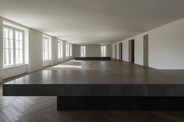 Leinwandbilder - A minimalist interior space with large, dark platforms and ample natural light.