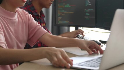 Slow motion back end software developer engineer for computer programming working together on debugging writing computing code, solving complex algorithms display on monitor in office. Burgeoning